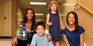 students of all grades sitting on school staircase